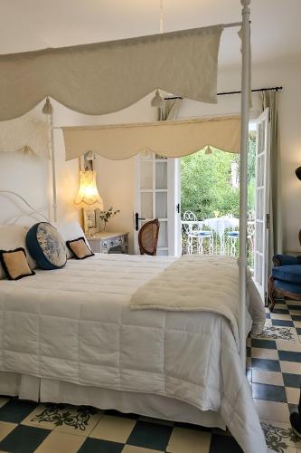 a bedroom with a white bed with a canopy at Villa Vicuña Salta Hotel Boutique in Salta