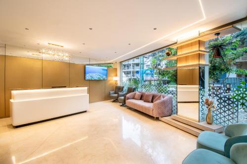 a lobby with a reception desk and chairs at Hotel Lenexa by Bestinn Leisure in Bengaluru