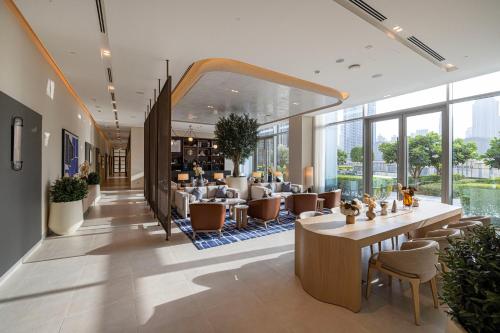 a lobby of a hotel with tables and chairs at Vida Dubai Mall! 2 Bedroom with Burj Khalifa View! Direct Access to Dubai Mall in Dubai