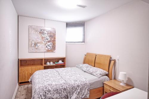 ヴォーンにあるSoho, Comfortable with Free Parking Spot on basementのベッドと壁に絵が飾られた寝室