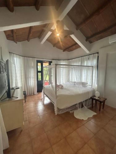 a bedroom with a bed and a television in it at Luxury Penthouse suite in Altos del Maria in Sorá
