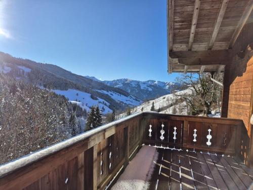 a bench on a balcony with a view of mountains at Achthütte in Grossarl