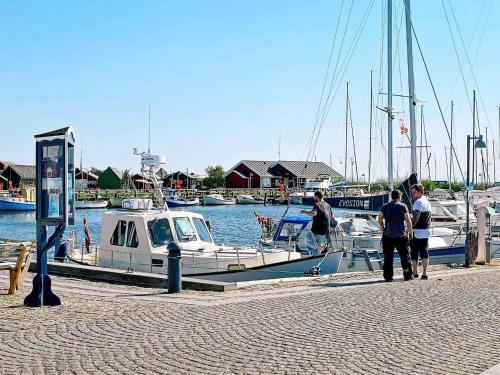 a group of people standing on a dock near a boat at 8 person holiday home in Ringkøbing in Ringkøbing