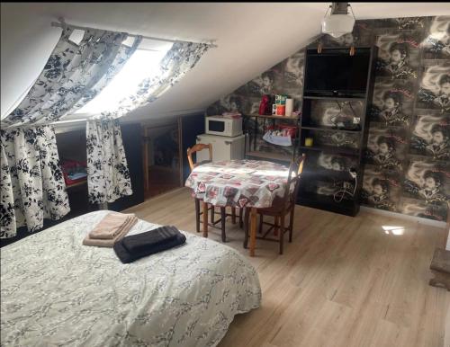 a bedroom with a bed and a table and a window at Voyage in Ouroux-sur-Saône