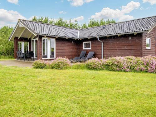 a small house with a lawn in front of it at 4 star holiday home in Ansager in Ansager