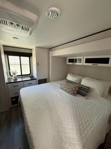 a bedroom with a large white bed and a window at Beachfront Retreat w Pool, Boat Ramp & Dock Rental in Key Largo