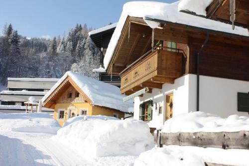a building covered in snow with snow piled up at Stallerhütte in Bachwinkl