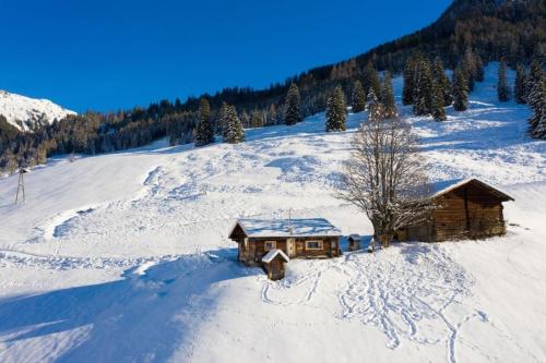 a cabin in the snow on a mountain at Hungarhub Hütte in Grossarl