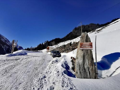 a truck driving down a snow covered road at Alpennestl in Ginzling
