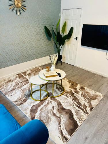 a living room with a table and a couch at Walsall Comfort Home 3Bedroom Retreat Sleeps 6 in Bescot