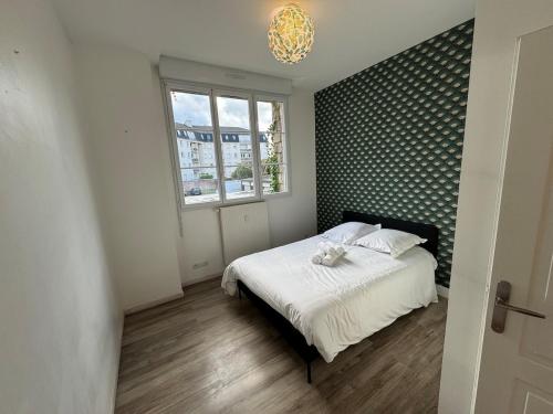 Ένα ή περισσότερα κρεβάτια σε δωμάτιο στο Appartement lumineux et moderne proche gare