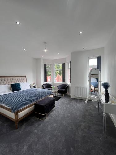 a large bedroom with a bed and a mirror at The Central Haven in Manchester