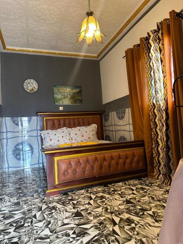 a bedroom with a bed and a ceiling at Skyatlantic guesthoüse in Douala