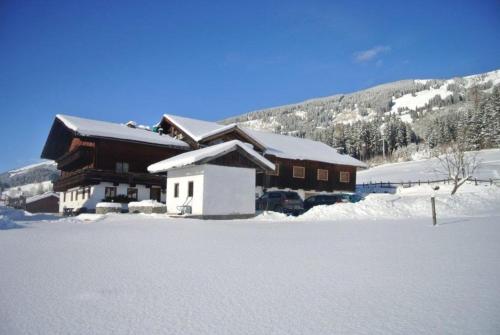 a building with snow on the ground in front of it at Bauernhaus Hollersbach in Hollersbach im Pinzgau