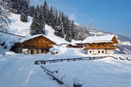 a snow covered log cabin with snow on the ground at Chalet Kleinbretteneben in Unterberg