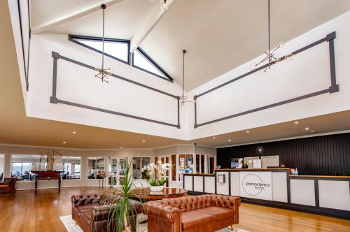 a large lobby with leather furniture and a piano at Panorama Hotel St Helens in St Helens