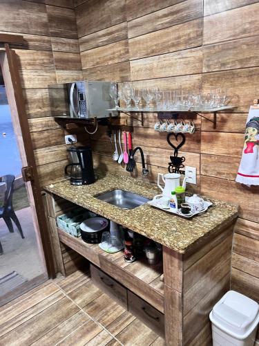 a kitchen with a sink and a counter at Casa Lagoa da Diva in Maricá