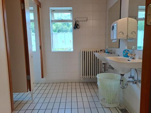 a bathroom with two sinks and a window at Studlagil INN Hostel in Skjöldólfsstaðir