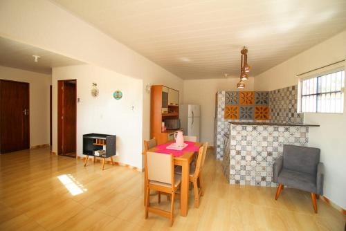 a living room with a table and a fireplace at Casa Jade Patacho in Pôrto de Pedras