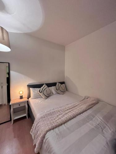 a bedroom with a bed with two pillows on it at SH Apartments in Hannover