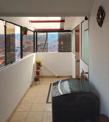 a room with a view of a city from a building at Sumaq Tika in Cusco