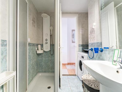 a bathroom with a sink and a washing machine at Seaside Escape in Benalmádena in Benalmadena Costa