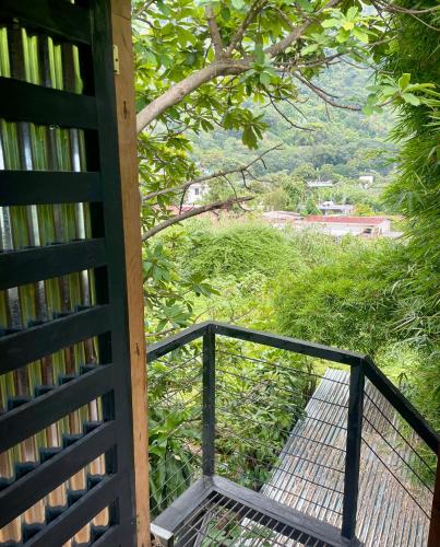 a balcony with a metal railing and a walkway at EB5 Escape Tzununa, Lake Atitlan Room #1 - two minute walk to the Lake in Santa Cruz La Laguna