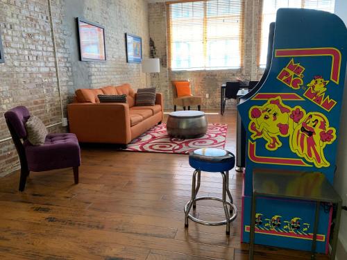 a living room with a large game room with a couch at Creole Nest in New Orleans