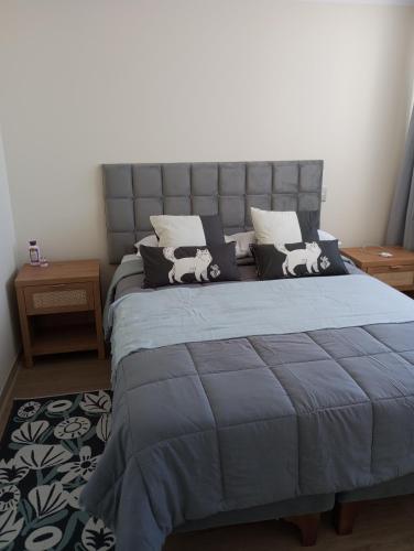 a bedroom with a bed with a blue comforter at Jardines del Pacifico in El Cerrillo