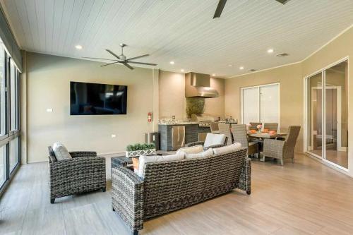 a living room with wicker furniture and a ceiling fan at The Riverview Estates Sauna And Heated Pool in Riverview