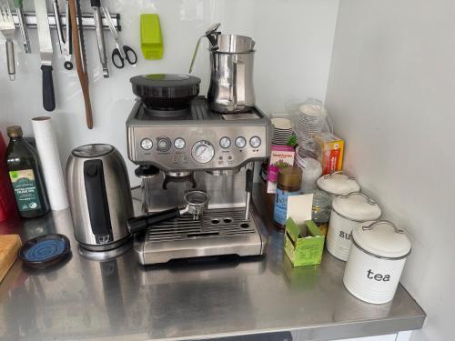 a kitchen counter with a coffee maker on top of it at Kelburn House at the top of the Cable Car in Wellington
