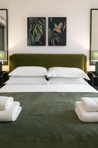 a bedroom with two beds with white pillows at Luxury flat with FREE parking & easy tube access! in London