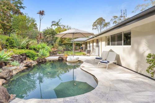 a swimming pool in the backyard of a house at The Hideaway in Tintenbar