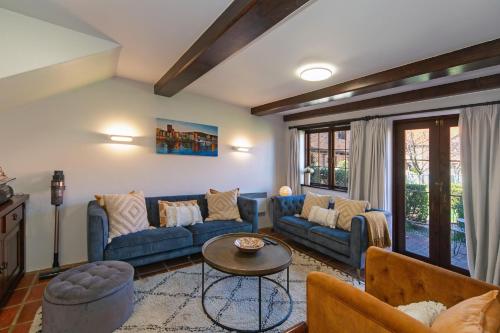 a living room with a blue couch and a table at Monaco Shores Apartment in Nelson