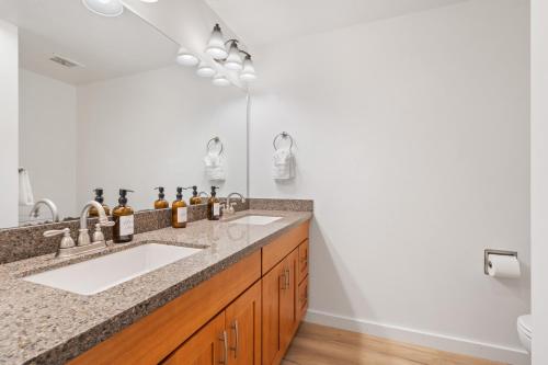 a bathroom with a sink and a mirror at Cedar Terrace Townhome w Firepit in Lynnwood