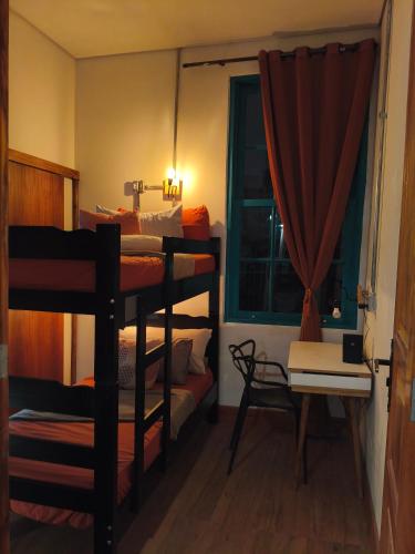 a room with three bunk beds and a window at Hobi Hotel Boutique - Bela Vista - Prox a Av Paulista in São Paulo