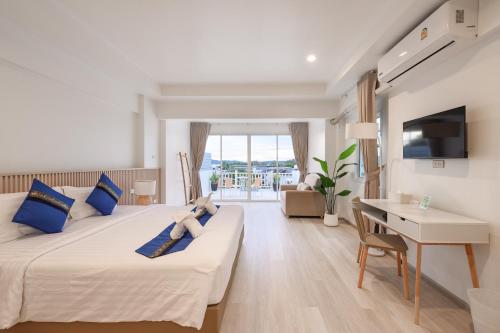 a living room with a large bed and a desk at Little Home Ao Nang in Ao Nang Beach