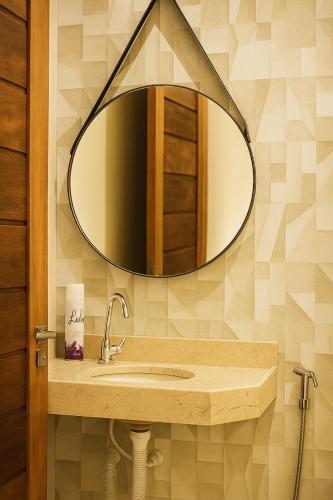 a bathroom with a sink and a mirror at Pousada do Andrade in Ponta Porã