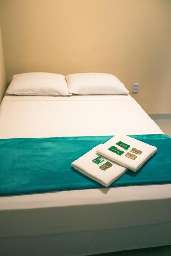 a bed with two thermometers sitting on top of it at Pousada do Andrade in Ponta Porã