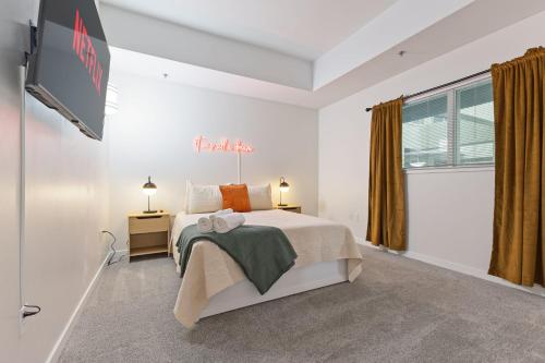 a bedroom with a bed and a flat screen tv at New Skywalk Access- Downtown Work Retreat- Sleeps8 in Indianapolis