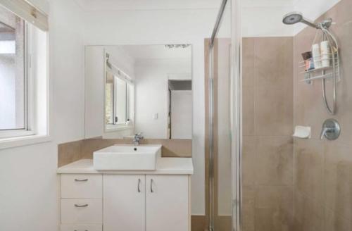 a bathroom with a sink and a shower at Syldah Stay Mango Hills in North Lakes