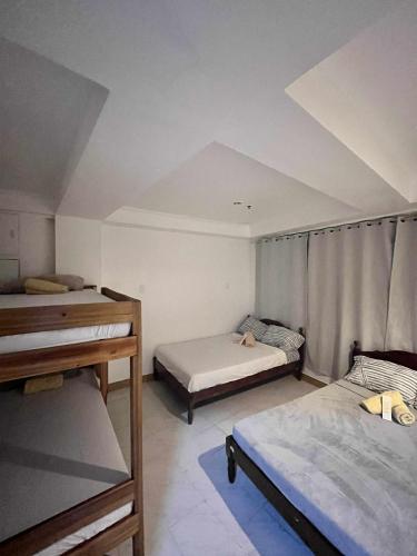a room with two beds and a ceiling at Ace Travellers Inn- Palawan in Puerto Princesa City