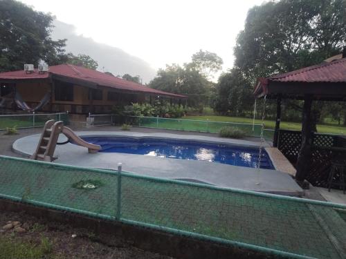 a swimming pool with a slide and a slide at Casa Relax La Fortuna in Fortuna