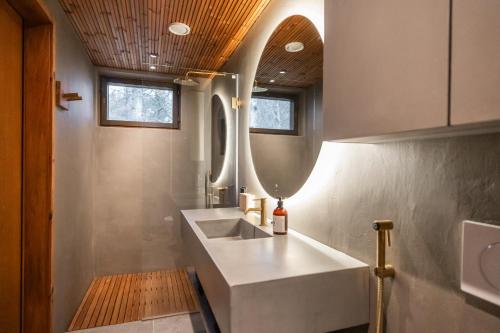 a bathroom with a sink and a mirror at Villa Amara & Private Spa in Rovaniemi