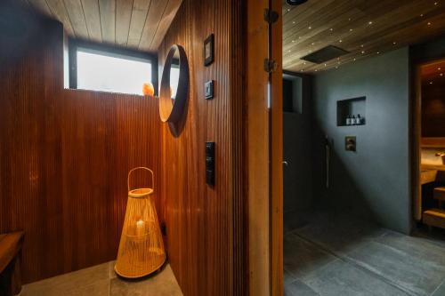 a wooden room with a light on the wall at Villa Amara & Private Spa in Rovaniemi