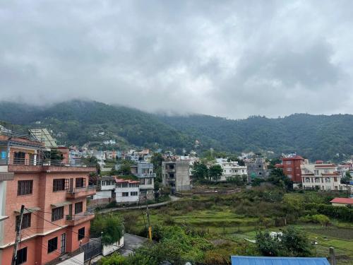 a city with houses and a mountain in the background at Shiv Tattva Yog School in Burhānilkantha