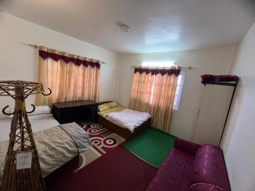 a small room with two beds and a couch at Shiv Tattva Yog School in Burhānilkantha