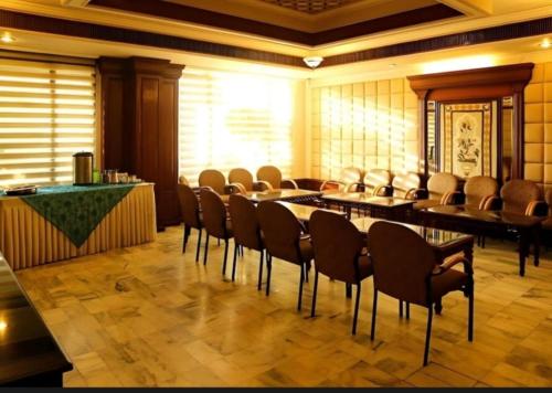 a room with chairs and a table and a bar at hotel red creek in Visakhapatnam