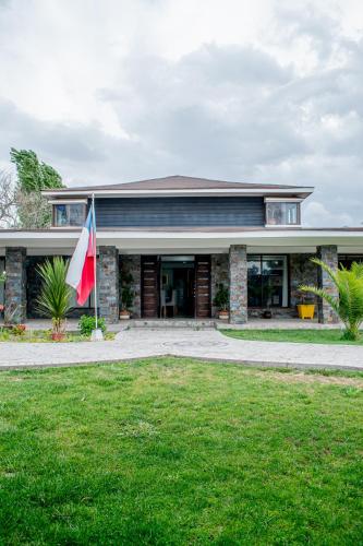 a house with a flag in front of it at Spa la casona de pirque in Pirque