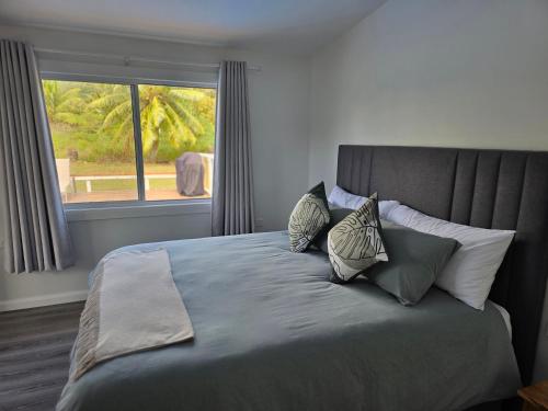 MataveraにあるT&T Retreatのベッドルーム1室(大型ベッド1台、枕付)、窓が備わります。